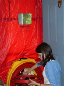 Graduate student Sarah Barnett uses a blower door to measure airtightness.