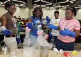 VESTED students (pictured) take part in a chemical engineering demonstration presented by employees of Air Products and Chemicals.