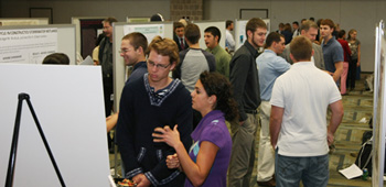 Adrienne (foreground, right) explains her poster at Villanova’s Undergraduate Research Poster Day on October 3.  
