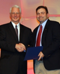 Kenneth C. Hover, President of the American Concrete Institute, presents Dr. Shawn Gross, Associate Professor of Civil and Environmental Engineering, with his award.