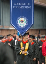 Matthew Brawley  ’13 ECE carries the Engineering banner at Commencement
