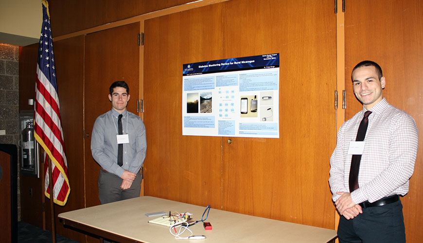 Neil MacFarlane and Tyler Turelli display their diabetes monitoring device.