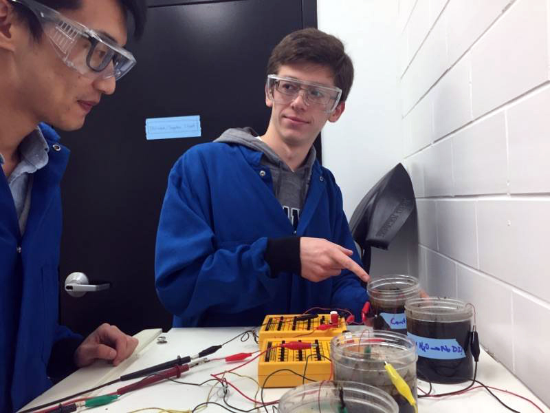 Chemical Engineering sophomore Brendan Gorman works with PhD student Xianhua Li on microbial fuel cell research in Dr. Huang’s lab.