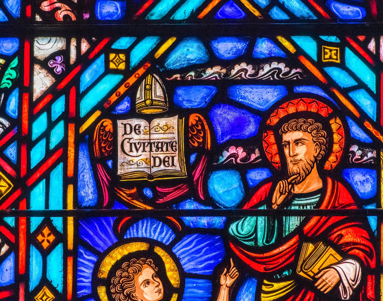 stained glass windows showing Agustine and his volume "City of God"