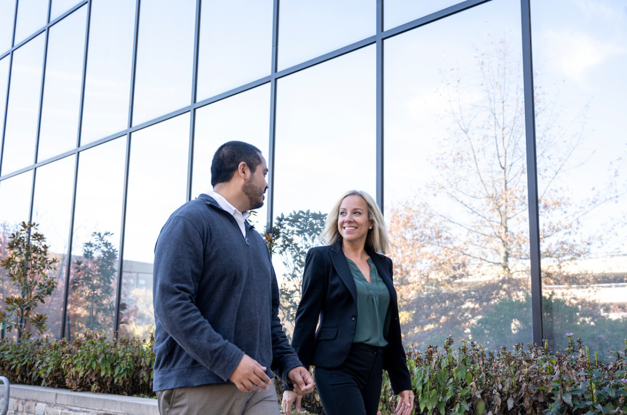 two people walking outside a building