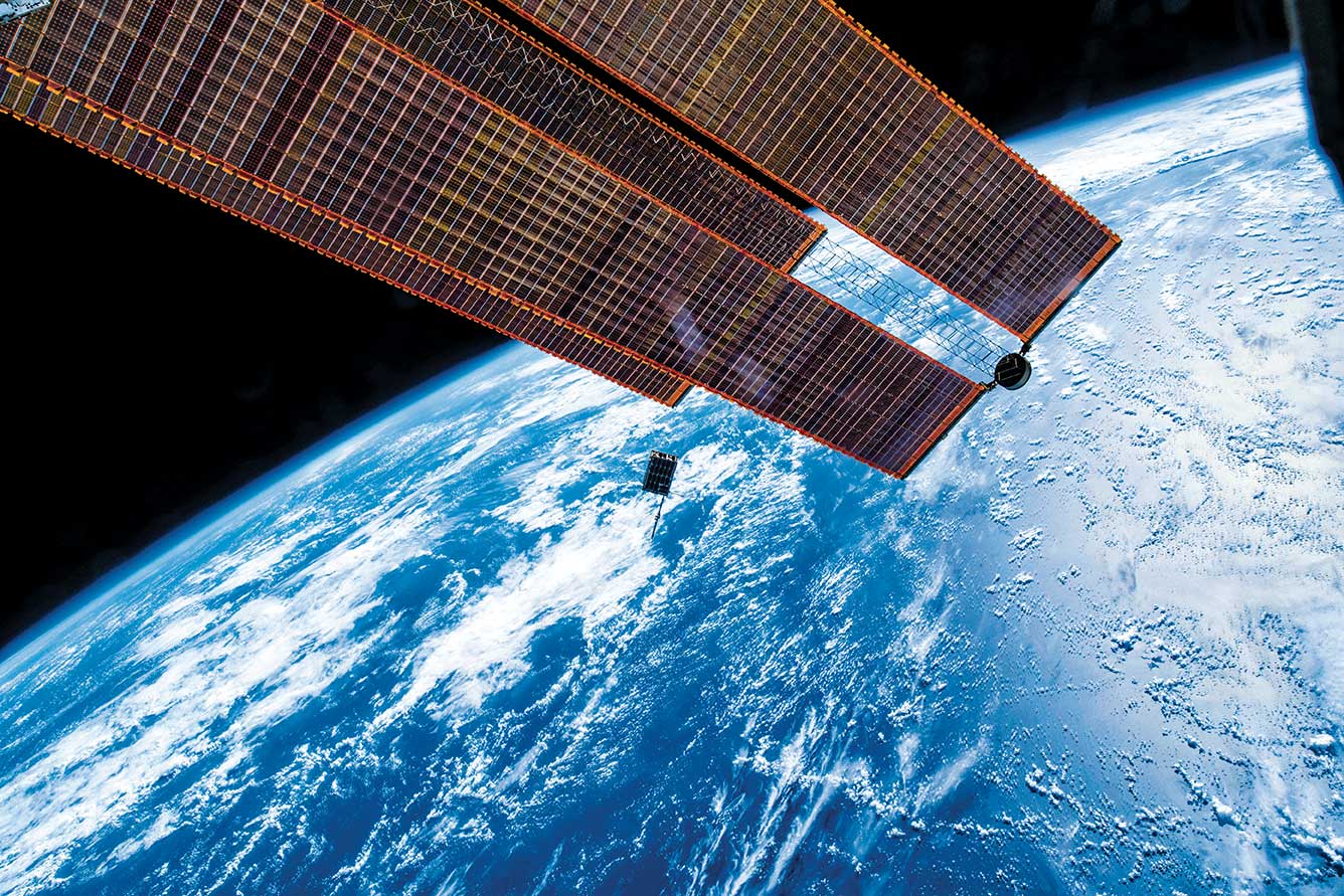 CubeSat technology floating in space above the earth