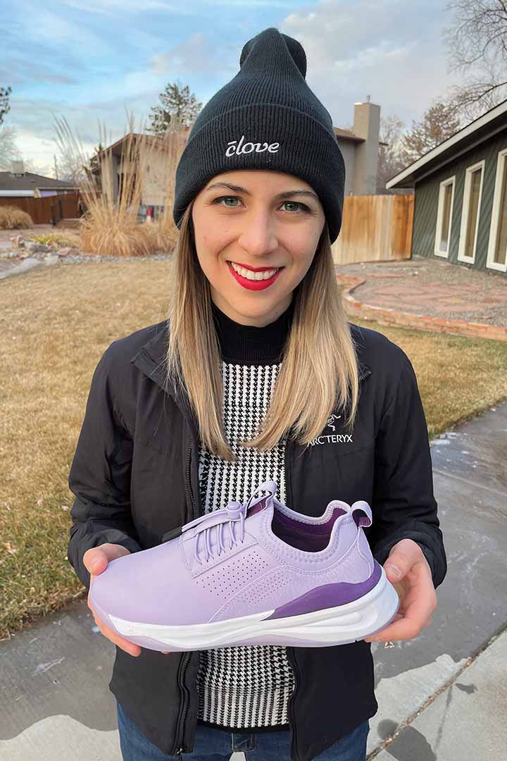 Paula Belatti holding a purple Clove sneaker
