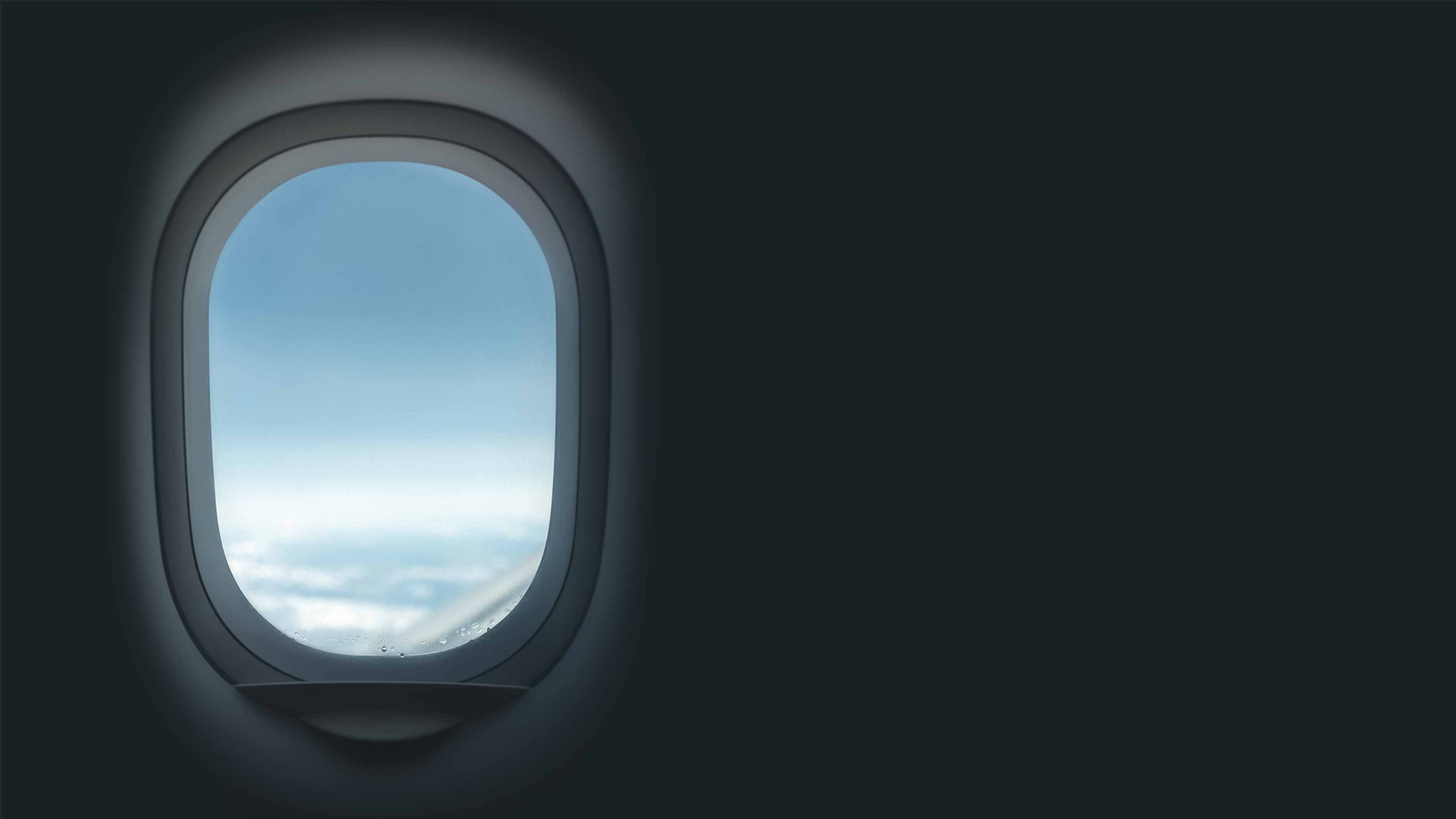 airplane window with blue skies