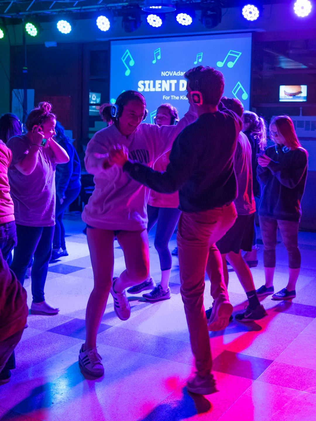 Villanova students dancing at a colorful silent disco.