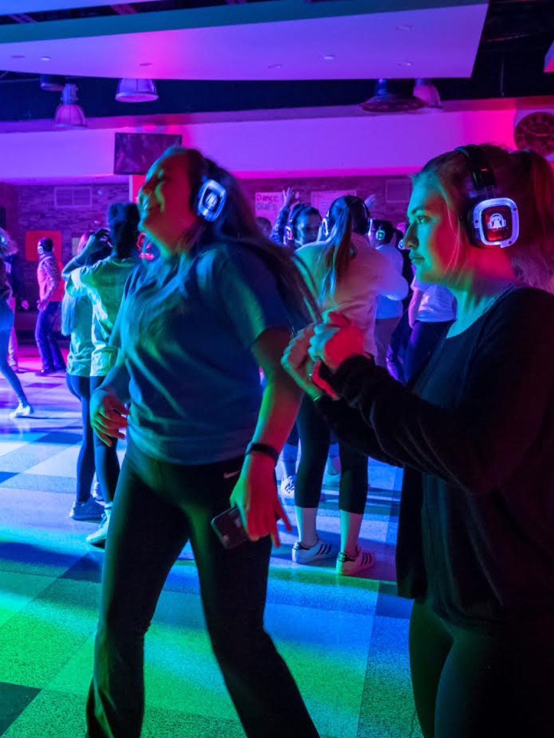 Villanova students dancing at a colorful silent disco.
