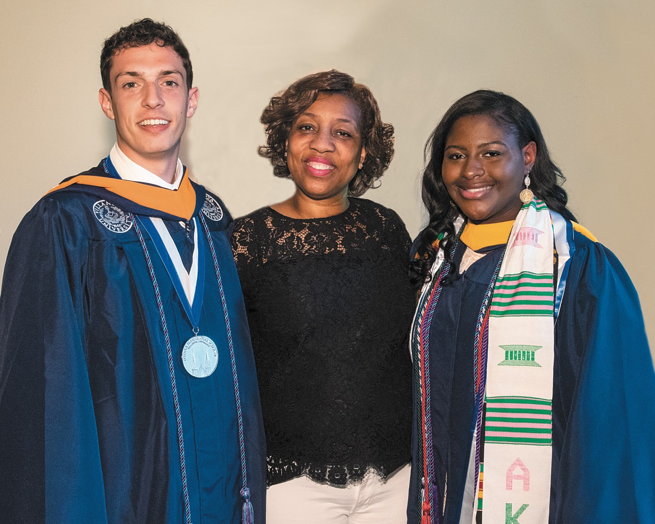 Recent graduates Alex Alberti and Mafatta Janeh in regalia with mentor and O’Toole Scholar Committee Member Nicole Davis