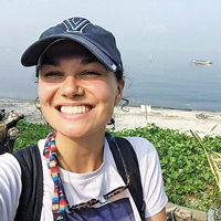 A selfie of U.S. Fulbright Student Grant recipient Elizabeth O’Brien with the beach in the background in the Philippines