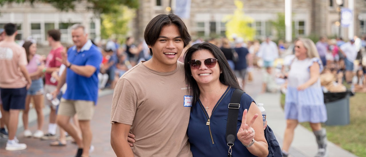 Mother and son outside at new student orientation