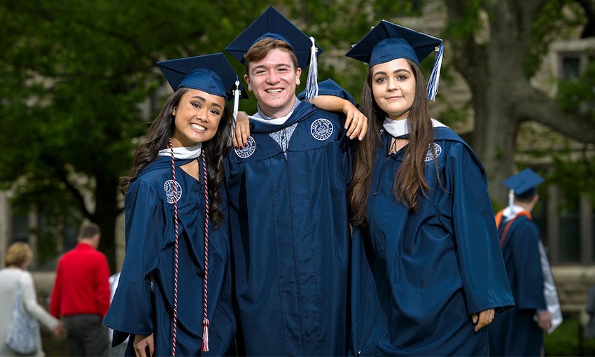 Three students in cap and gown