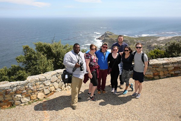 EMBA students stand on a coastal overlook.