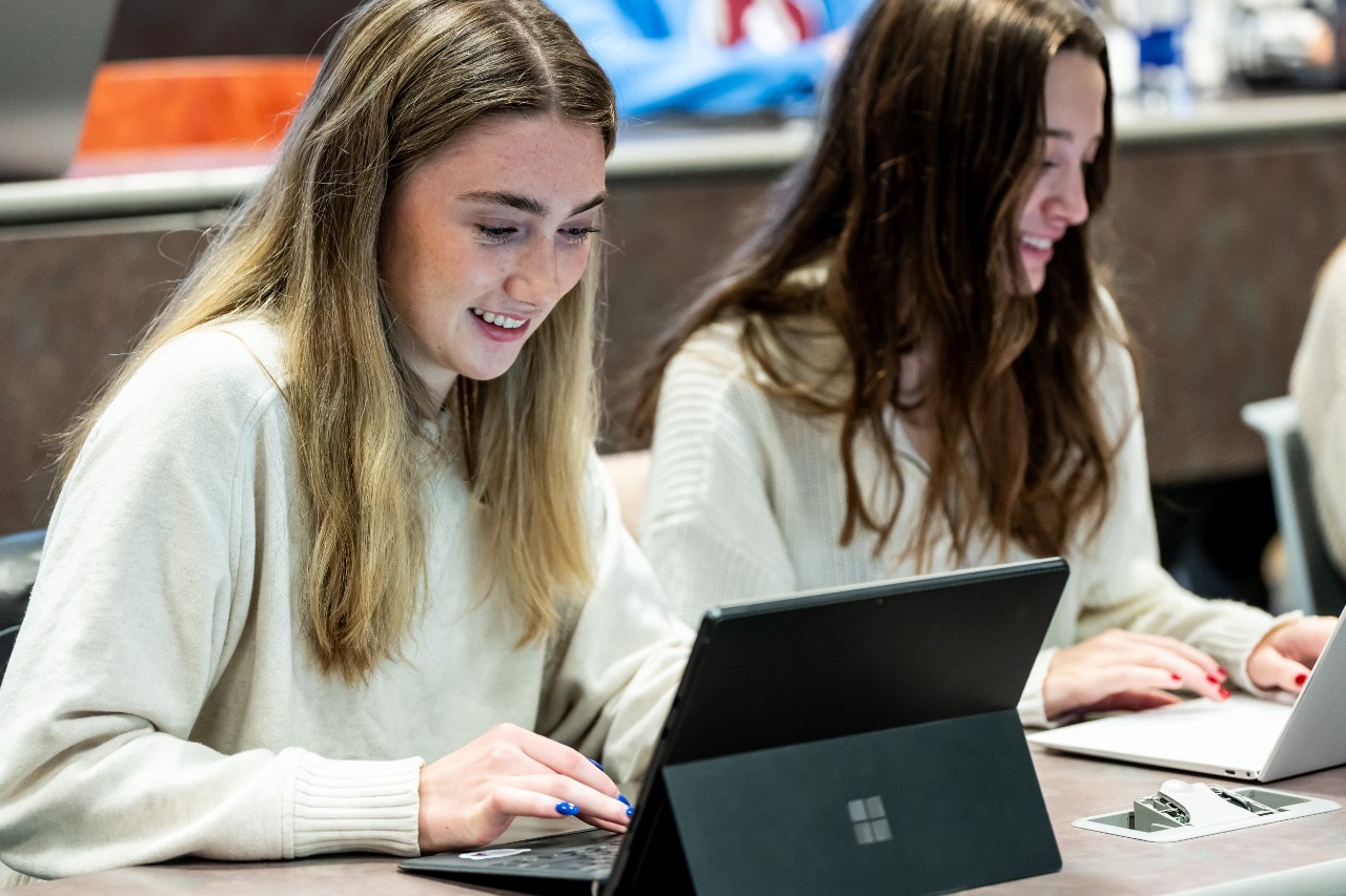 students collaborating in class in front of a computer