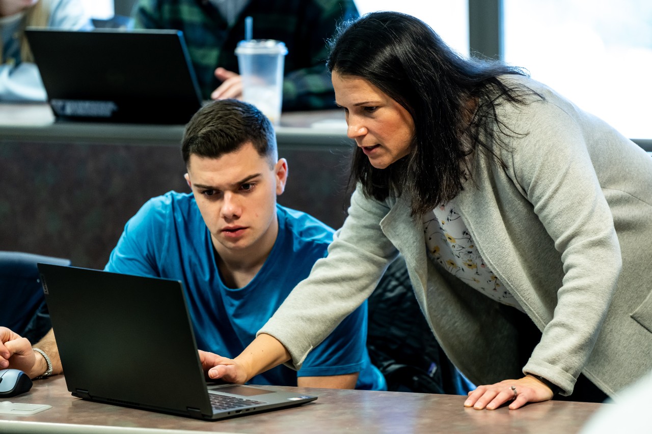 professor working with student on computer