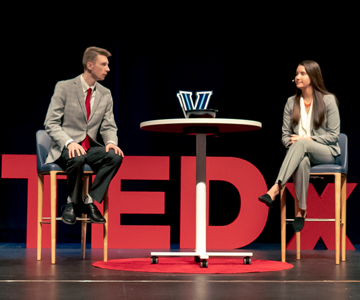 Students sitting in front of TedX logo