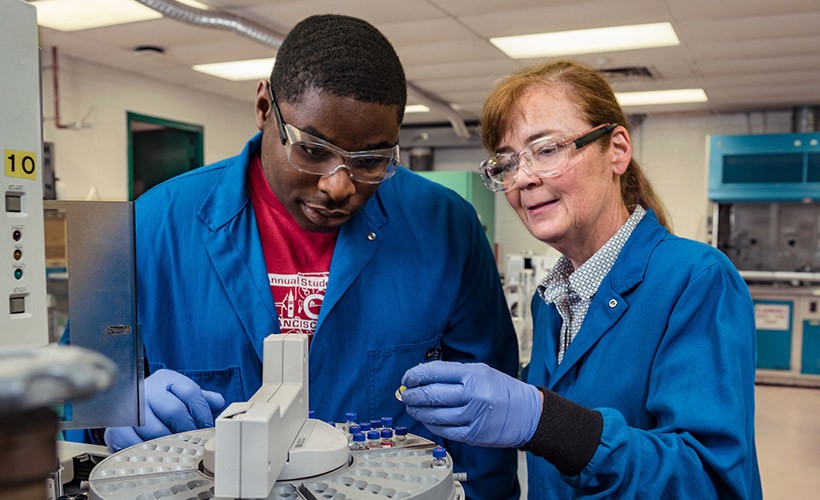 Dorothy Skaf, Associate Professor of Chemical Engineering, works with a student in the lab.