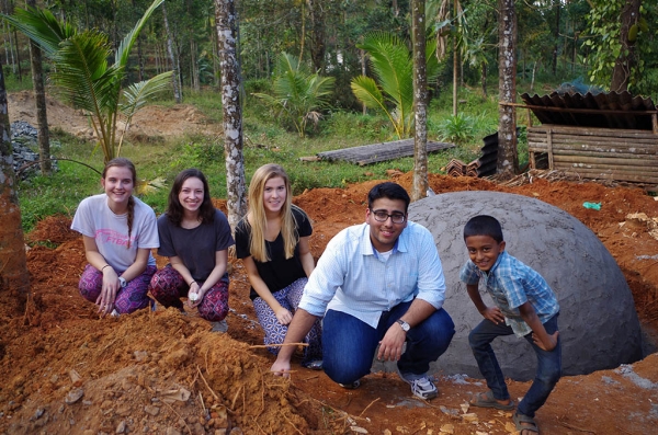 Villanova students posing with a biogas digester