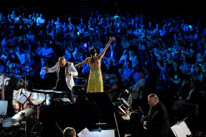 Sutton2025 Singer performing on a stage next to a conductor