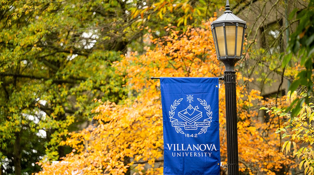 fall-banner Villanova lightpost banner in front of fall leaves