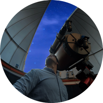 A student stares up at the stars from the observatory.