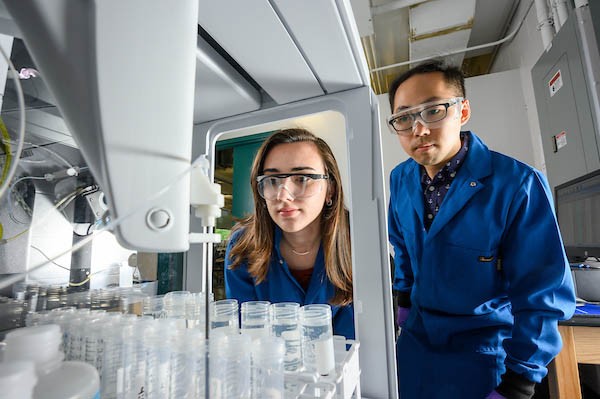 Two student-researchers working in a laboratory.