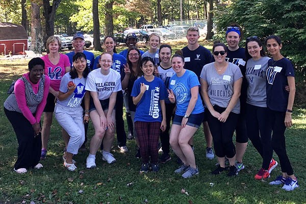 Graduate students pose for photo after participating in St. Thomas of Villanova Day of Service.