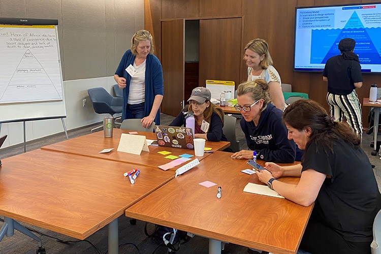 Faculty and staff working at a table during a workshop session