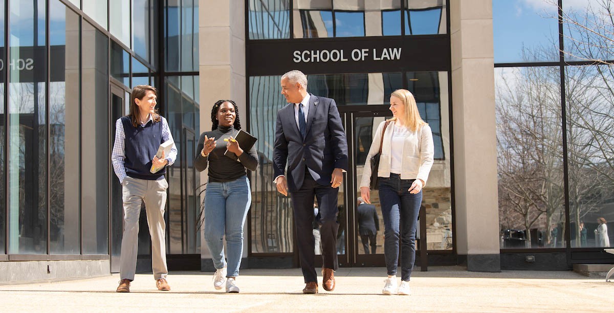 Students with the Dean outside the Law School.