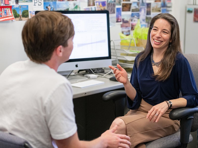 Deena Weisberg, PhD, talks to a student,