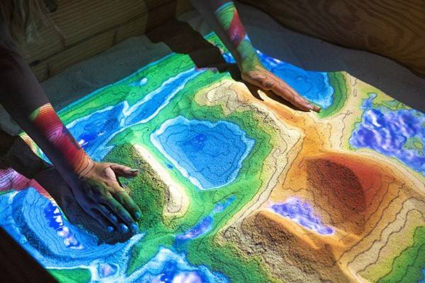 Student works in the augmented reality sandbox.
