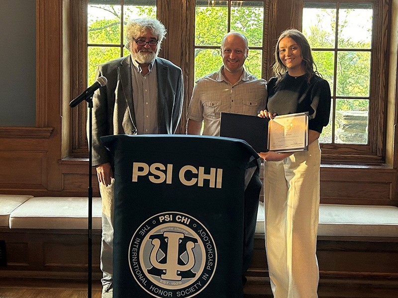 Kerry Buckhaults '23 MS (right) receives the Ingeborg L. and O. Byron Ward Outstanding Thesis Award from Psychological and Brain Sciences Chair Mike Brown, PhD, (left) and thesis advisor Ben Sachs, PhD.