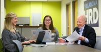 HRD students and faculty working together at a table