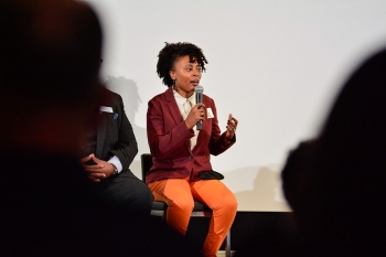 image of woman on stage with microphone