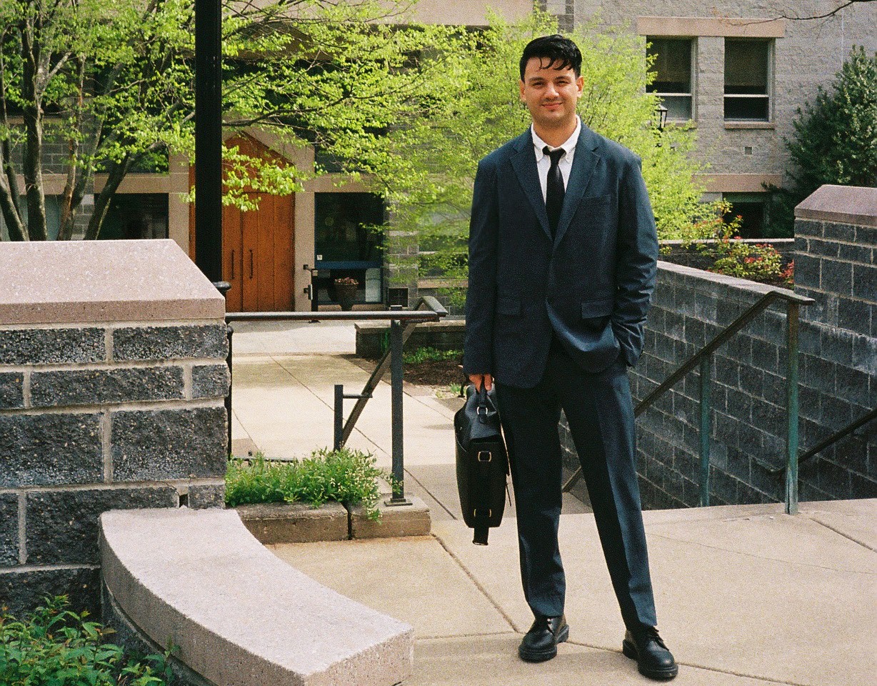 Christopher Quintana ’24 PhD in front of the St. Augustine Center