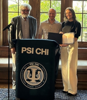 Kerry Buckhaults '23 MS (right) receives the Ingeborg L. and O. Byron Ward Outstanding Thesis Award from Psychological and Brain Sciences Chair Mike Brown, PhD, (left) and thesis advisor Ben Sachs, PhD.