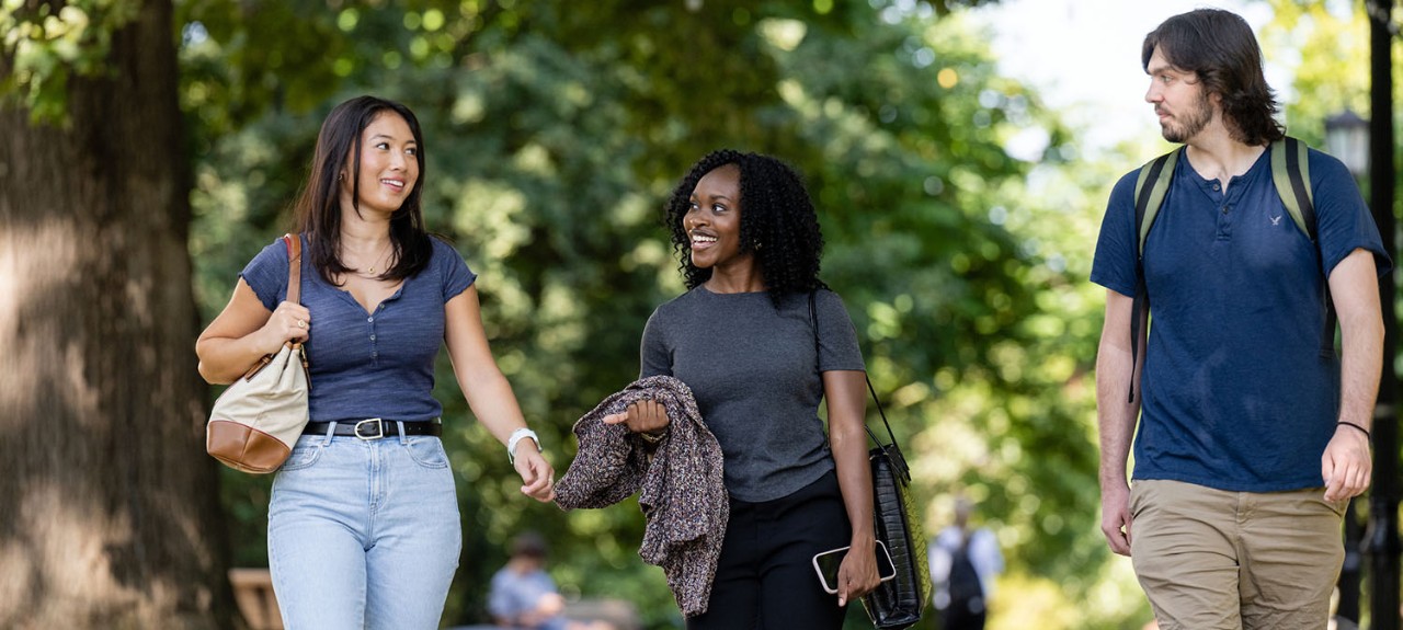 Graduate students walking across campus