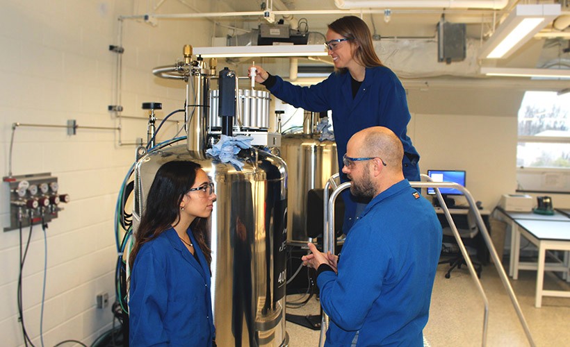 A professor and two students in the lab.