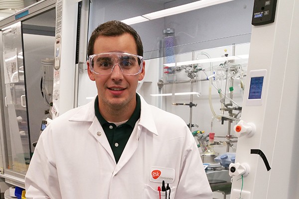 Alex Reif stands in a lab at GlaxoSmithKline.