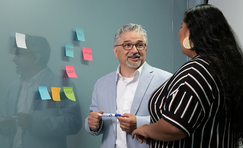 Edward Fierros, PhD, associate dean for UNITAS: Inclusive Education, talks with a student. Edward Fierros, PhD, associate dean for UNITAS: Inclusive Education, talks with a student.
