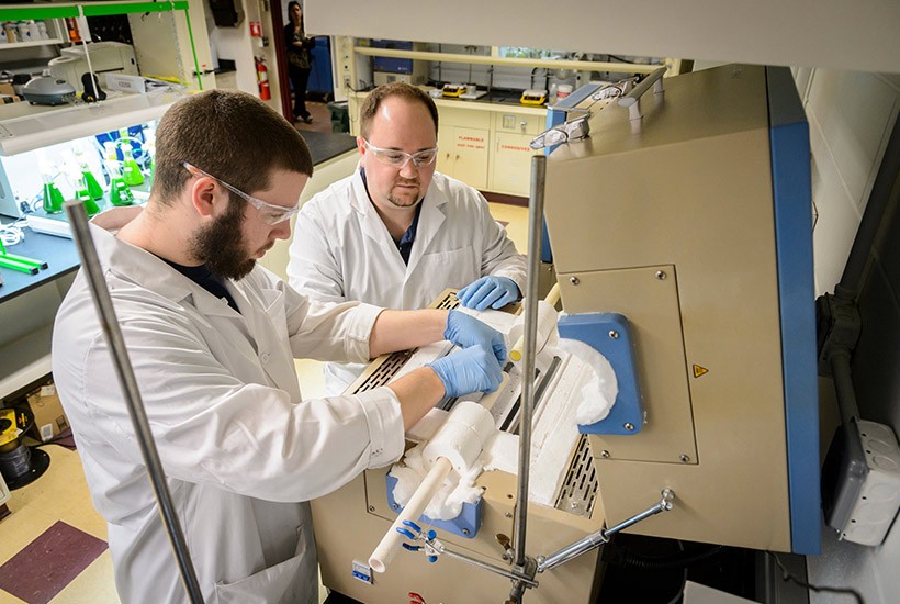 A student and professor work in the lab.