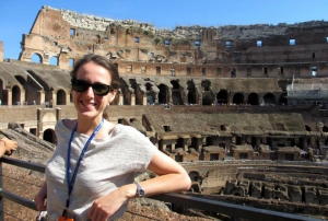 Megan Quinn standing in front of the Colosseum