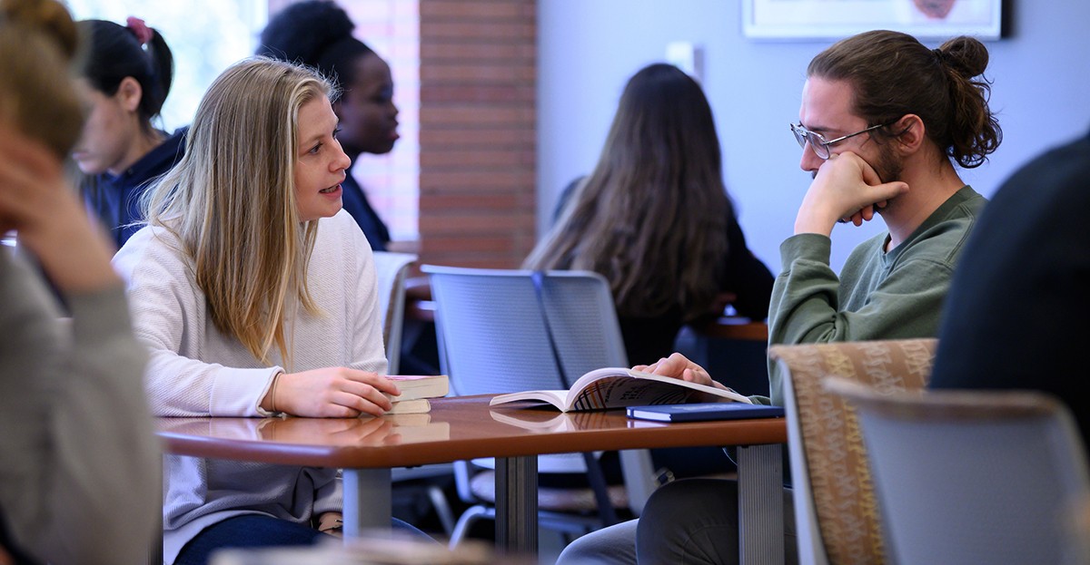 graduate students working together in the library
