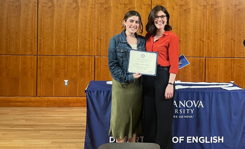 English student holding up award