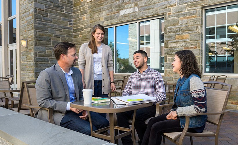 Students meet with professor outdoors
