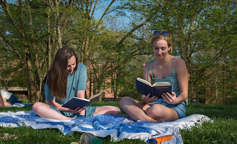 Students reading outside