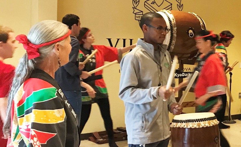 Student participating in a Taiko demonstration.