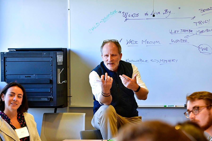 Professor engaging a classroom of Humanities alumni.